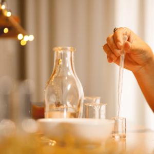 Perfumer using glass tools and essential oils