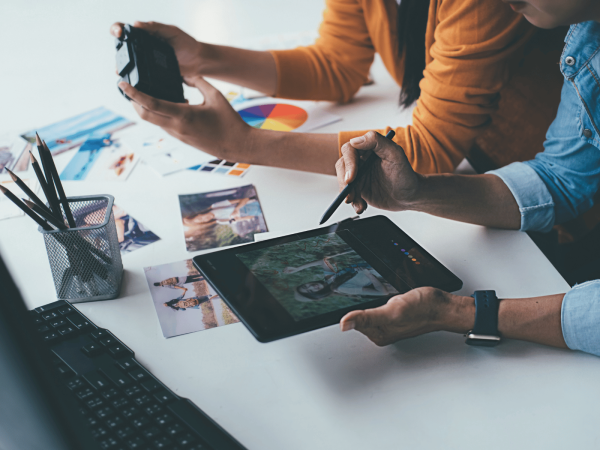 Desk with people working on devices